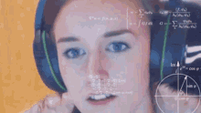 a woman wearing headphones is looking at a computer screen with math equations on it .