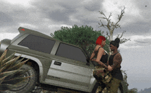 a man and a woman are standing next to a jeep that says u.s. army on the side