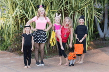 a group of children dressed in halloween costumes are posing for a photo