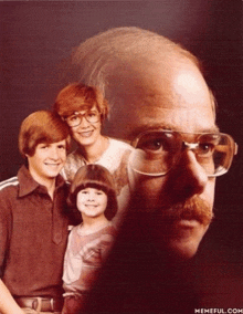 a family photo with a man wearing glasses