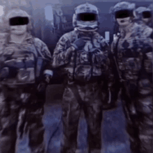 a group of soldiers are standing next to each other with their faces covered