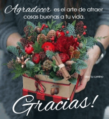 a woman is holding a box of flowers with the words " gracias " below it