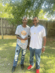 two men standing next to each other one wearing a teddy bear shirt