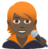 a man with orange hair is holding a microphone and smiling