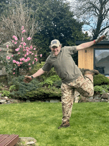 a man with his arms outstretched is standing in a garden