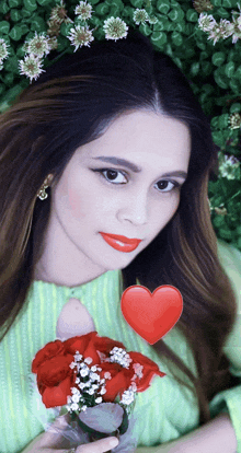 a woman holding a vase of red roses with a red heart above her head