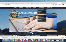 a saddle mountain website shows a person using a laptop