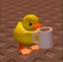 a yellow rubber duck is holding a cup of coffee on a brick floor .