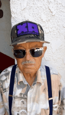 an elderly man wearing sunglasses and a hat that says authority.org