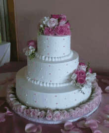 a white wedding cake with pink and white flowers