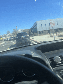 a car is parked in front of a building with a sign that says no parking