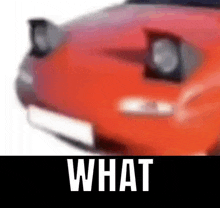 a blurry picture of a red sports car with the words `` what '' written above it .