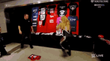 a woman is standing in front of a wall of t-shirts including one that says " never give up "