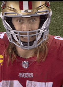 a football player wearing a 49ers jersey and a helmet