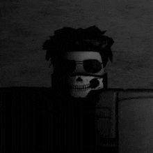 a man wearing a skull mask and sunglasses is in the dark .