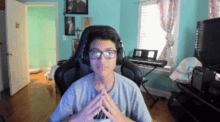 a boy wearing glasses and headphones is sitting in front of a piano