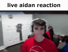 a boy wearing headphones is sitting in a chair in front of a computer monitor .