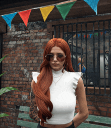 a woman with long red hair wearing sunglasses and a white crop top