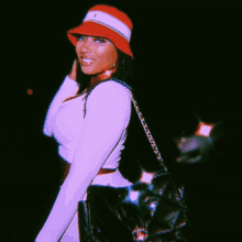 a woman wearing a bucket hat and a purse