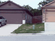 a car is parked in front of a house with a garage door that has the number 4335 on it