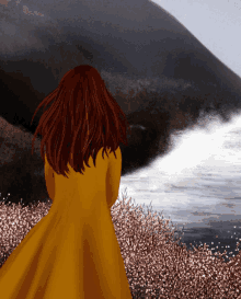 a woman in a yellow dress is standing in front of a body of water