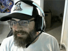 a man with a beard wearing headphones and a hat with a dog embroidered on it