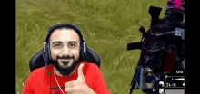 a man with a beard is wearing headphones and giving a thumbs up sign