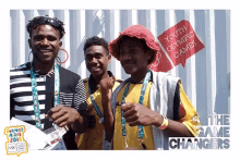 a group of young men are posing for a photo in front of a sign that says " youth olympic games "