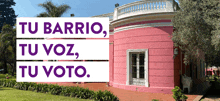 a pink house with the words tu barrio tu voz tu voto on it