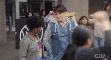 a man in a denim vest stands next to a woman holding a sign that says " i love you "