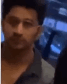 a close up of a man 's face in a blurry video .