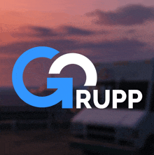 a blue and white logo for g rupp with a white truck in the background