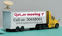 a qatar moving 7 truck with a table on top of it