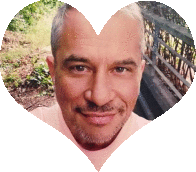 a man 's face is surrounded by a heart shaped frame