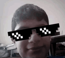 a boy wearing a pair of pixelated sunglasses with a checkered pattern