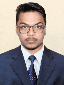 a man wearing glasses and a suit and tie