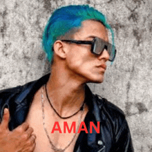 a man with blue hair is wearing sunglasses and a leather jacket and the word aman is on the bottom right