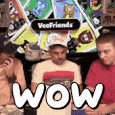 a group of men are playing a game called veefriends and one of them is wearing a red shirt