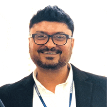 a man wearing glasses and a lanyard that says ' integrated '