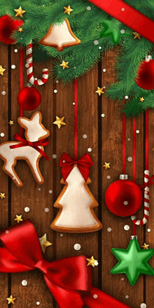 christmas decorations hanging on a wooden wall including a gingerbread tree