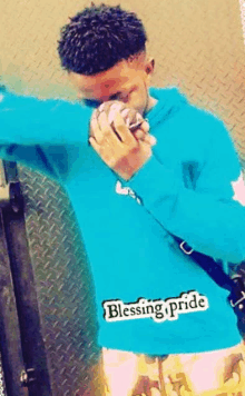 a man wearing a blue hoodie with blessing pride written on the sleeve