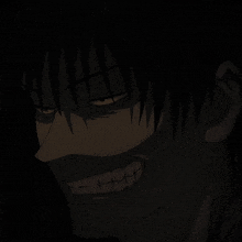 a close up of a person 's face in the dark with a smile on his face