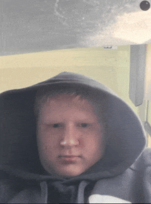 a boy wearing a hoodie with the letter b on the bottom