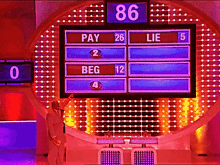 a man stands in front of a screen that says pay 26 lie 5 and beg 12