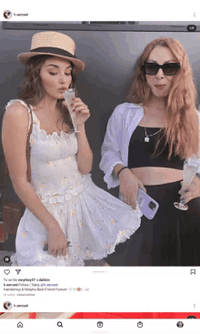 two women standing next to each other with one drinking a glass of champagne