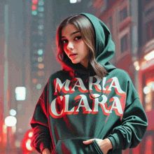 a woman wearing a green hoodie that says maria clara on it