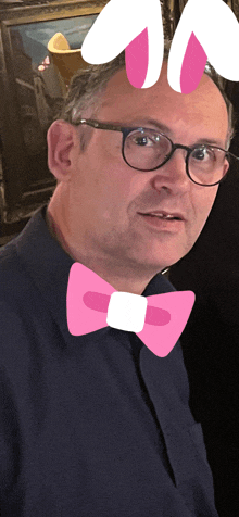 a man wearing glasses and a pink bow tie with bunny ears