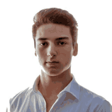 a young man wearing a white shirt has a serious look on his face