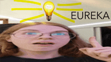 a girl with glasses and a light bulb on her head with the word eureka behind her