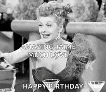 a black and white photo of a woman sitting at a table with martini glasses and a happy birthday message .